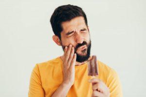 person eating a popsicle and having tooth sensitivity